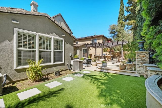 a view of a building with sitting area and garden