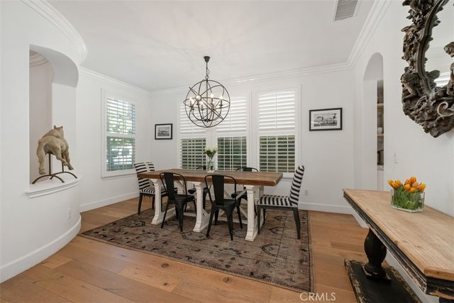 a view of dining room and livingroom with furniture wooden floor and a rug