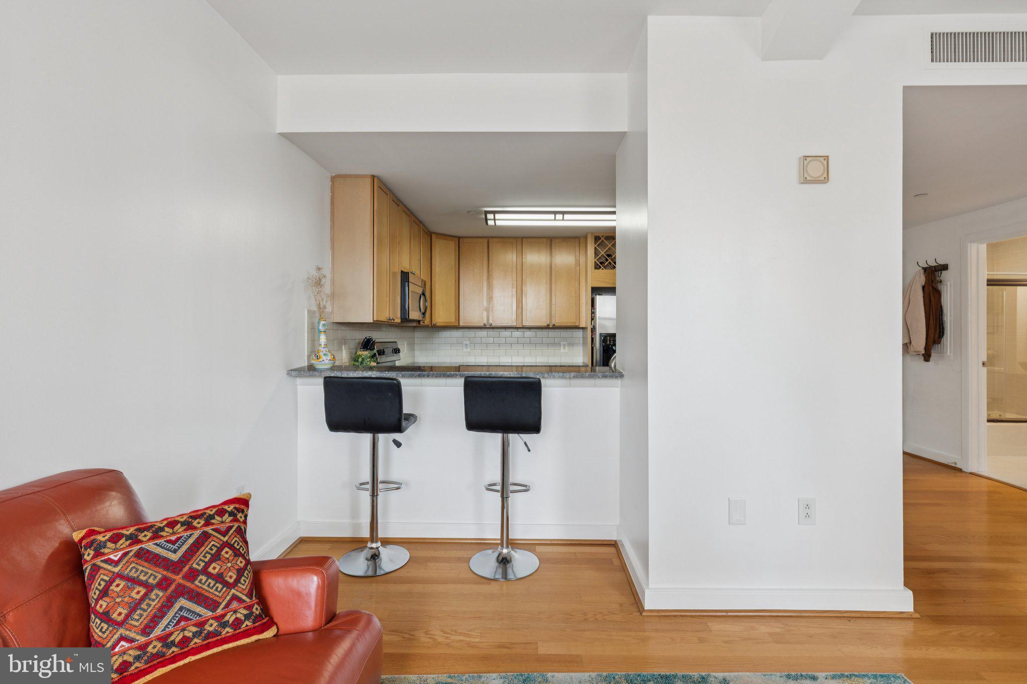 111 South 15th Street, Unit 2106 Philadelphia, PA 19102 - Photo 12 of 31 a kitchen with stainless steel appliances kitchen island granite countertop a refrigerator and a stove top oven