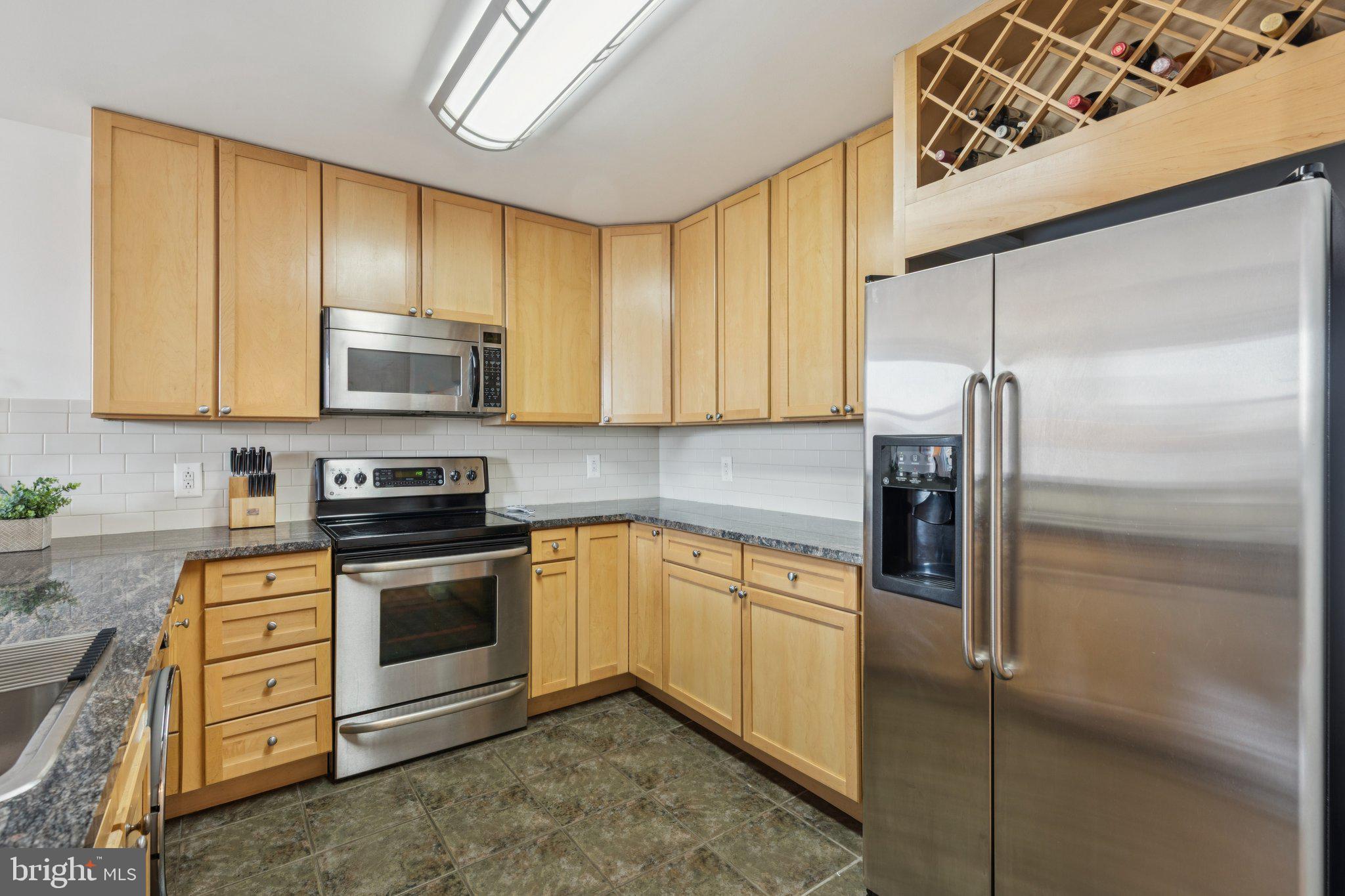 111 South 15th Street, Unit 2106 Philadelphia, PA 19102 - Photo 15 of 31 a kitchen with stainless steel appliances granite countertop a stove a sink and a refrigerator