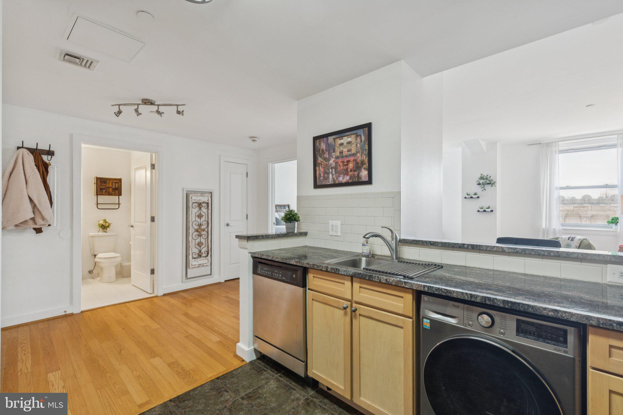 111 South 15th Street, Unit 2106 Philadelphia, PA 19102 - Photo 16 of 31 a view of a kitchen with stainless steel appliances granite countertop a sink and a cabinets