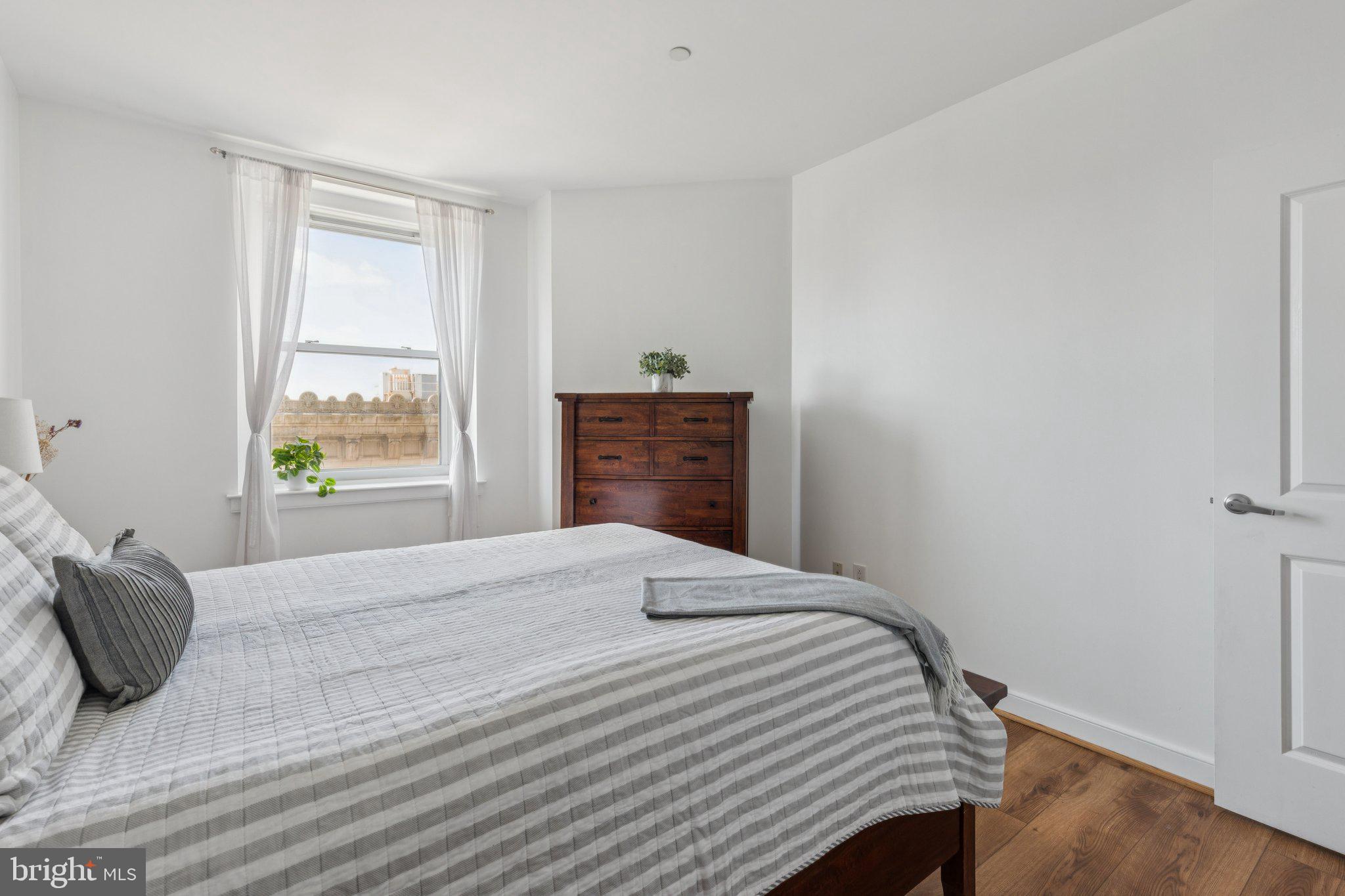 111 South 15th Street, Unit 2106 Philadelphia, PA 19102 - Photo 18 of 31 a bedroom with a bed and a window