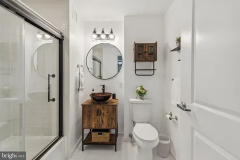 a bathroom with a toilet a sink and a mirror