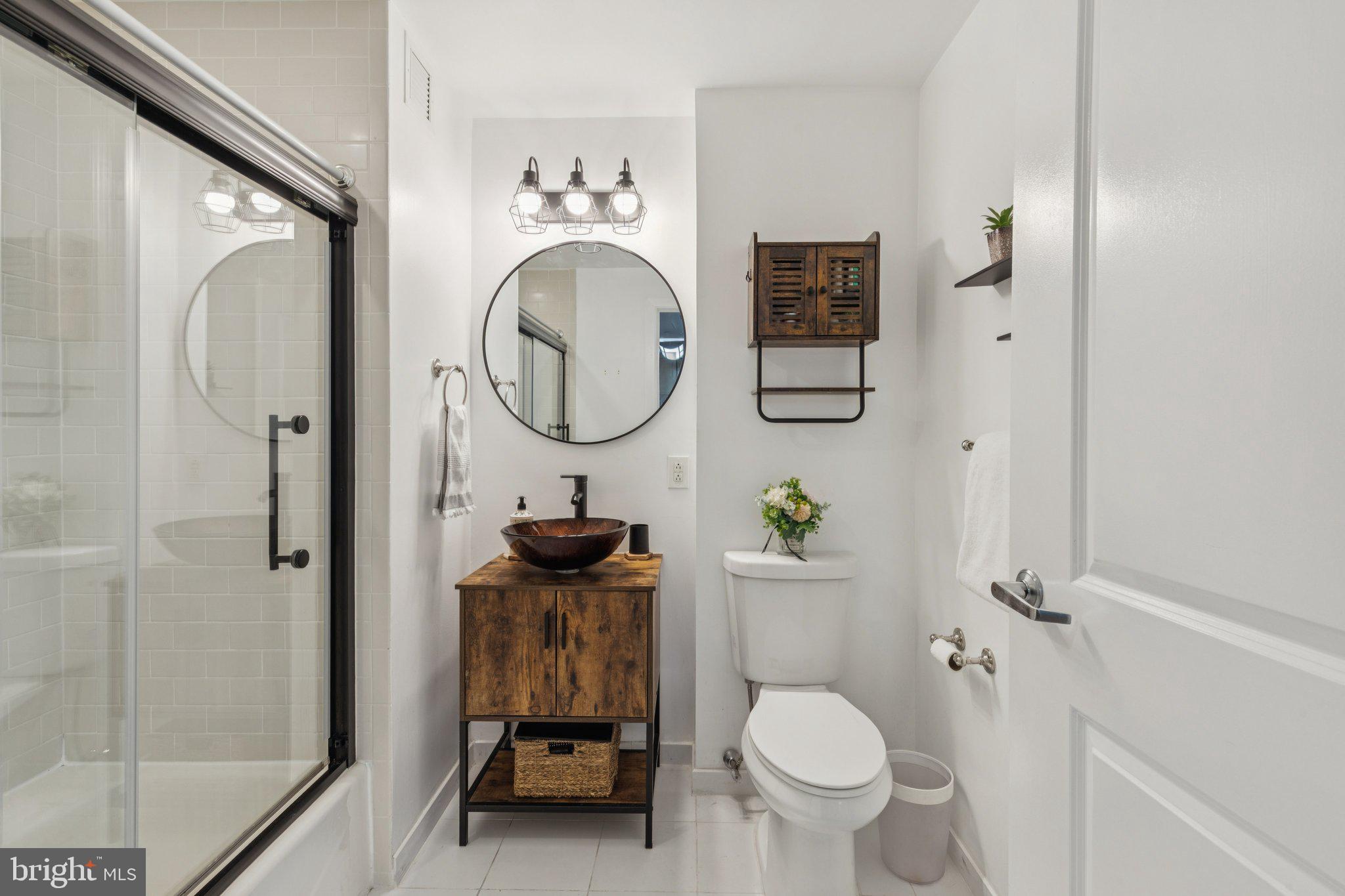 111 South 15th Street, Unit 2106 Philadelphia, PA 19102 - Photo 21 of 31 a bathroom with a toilet sink and a mirror