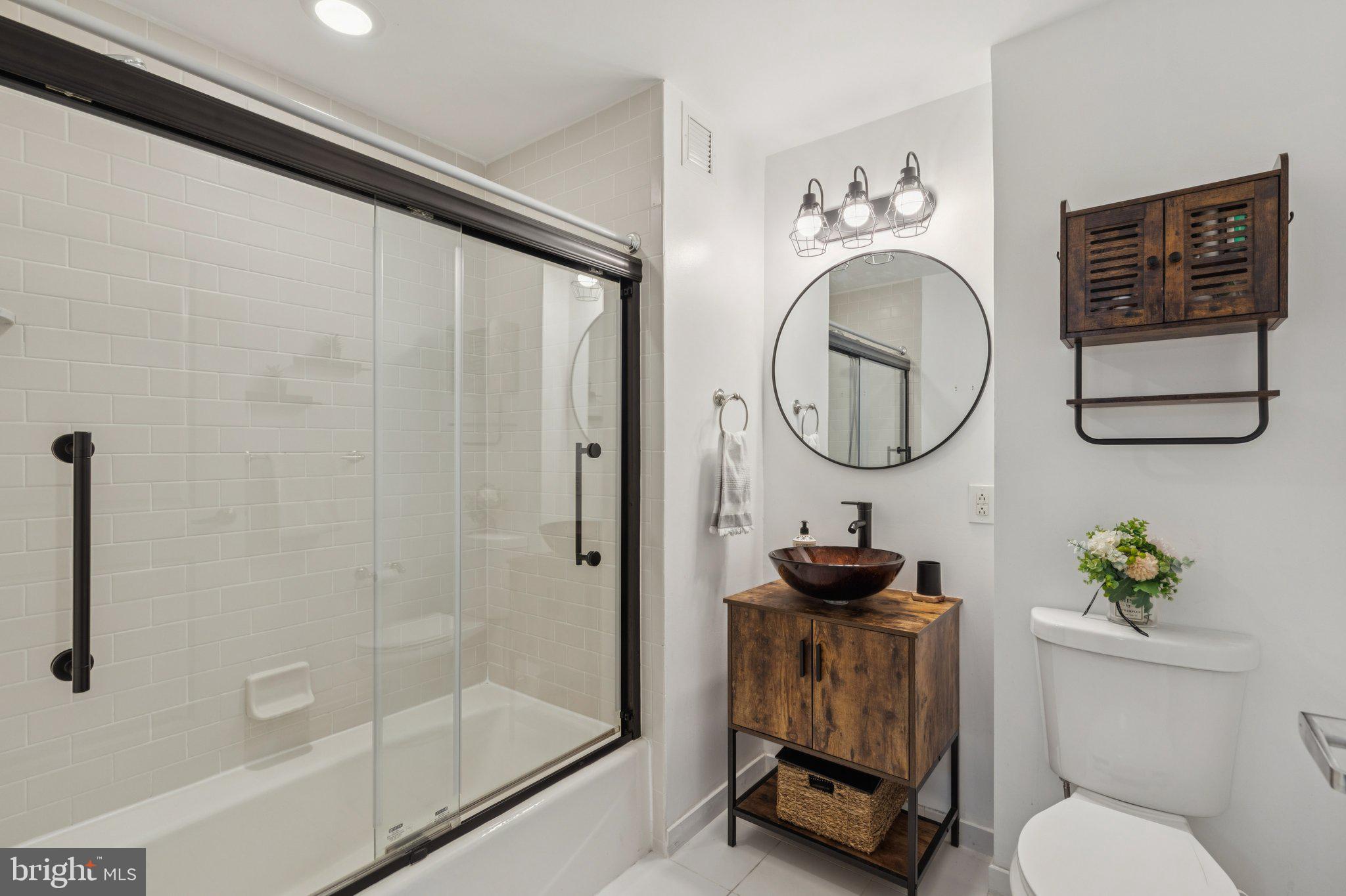 111 South 15th Street, Unit 2106 Philadelphia, PA 19102 - Photo 22 of 31 a bathroom with a toilet a sink and a mirror