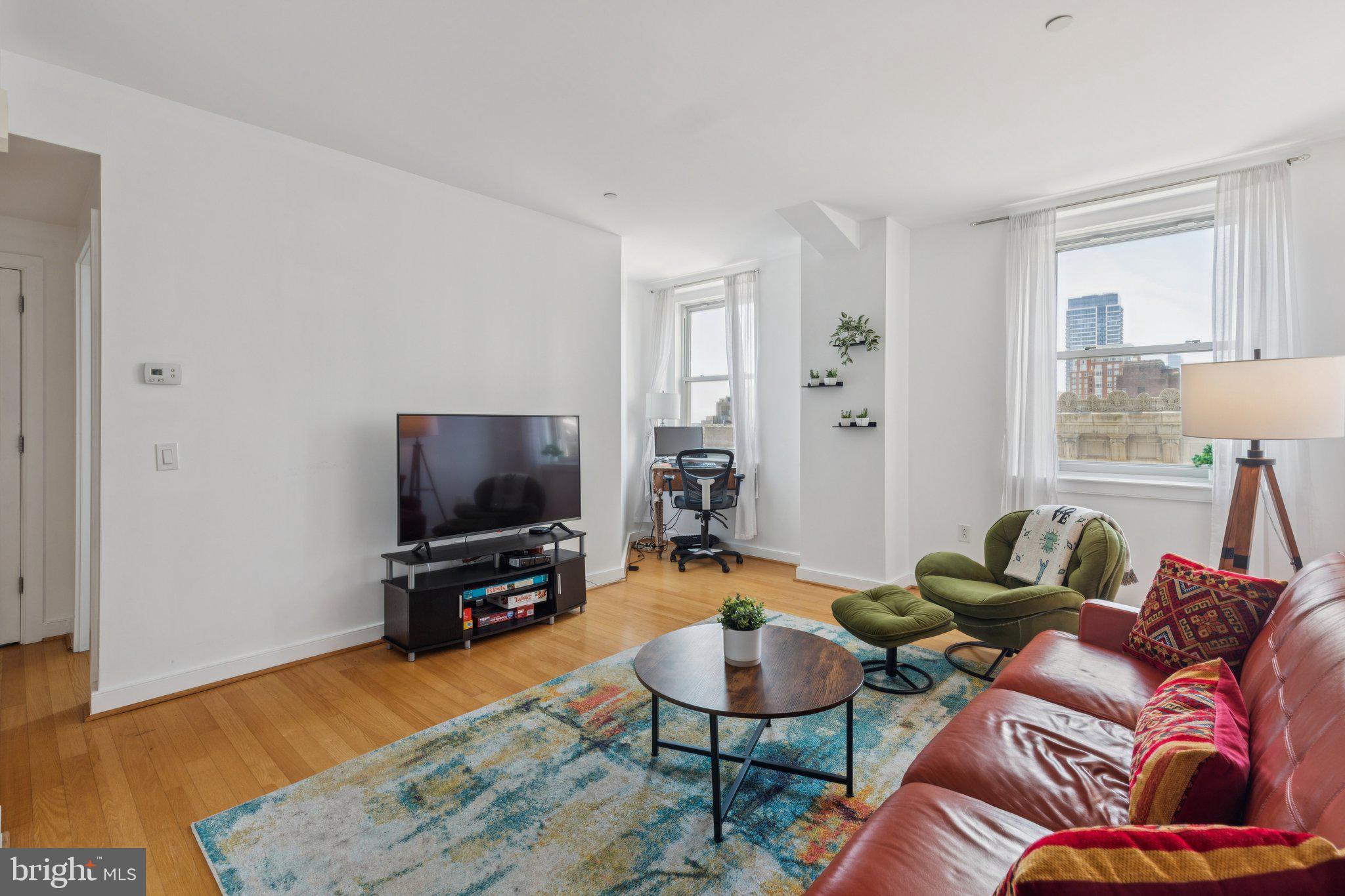 111 South 15th Street, Unit 2106 Philadelphia, PA 19102 - Photo 8 of 31 a living room with furniture and a flat screen tv