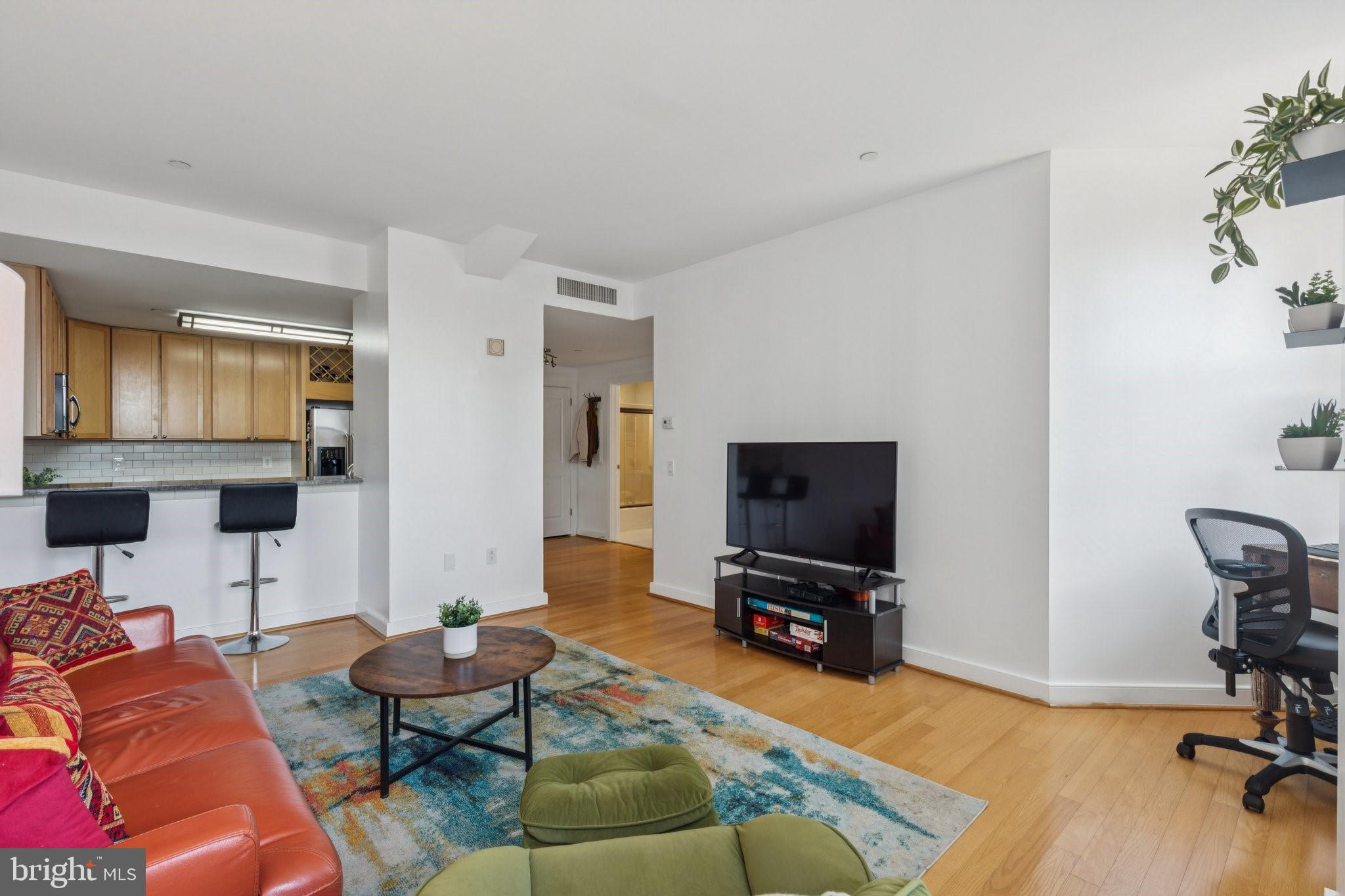 111 South 15th Street, Unit 2106 Philadelphia, PA 19102 - Photo 9 of 31 a living room with furniture and a flat screen tv