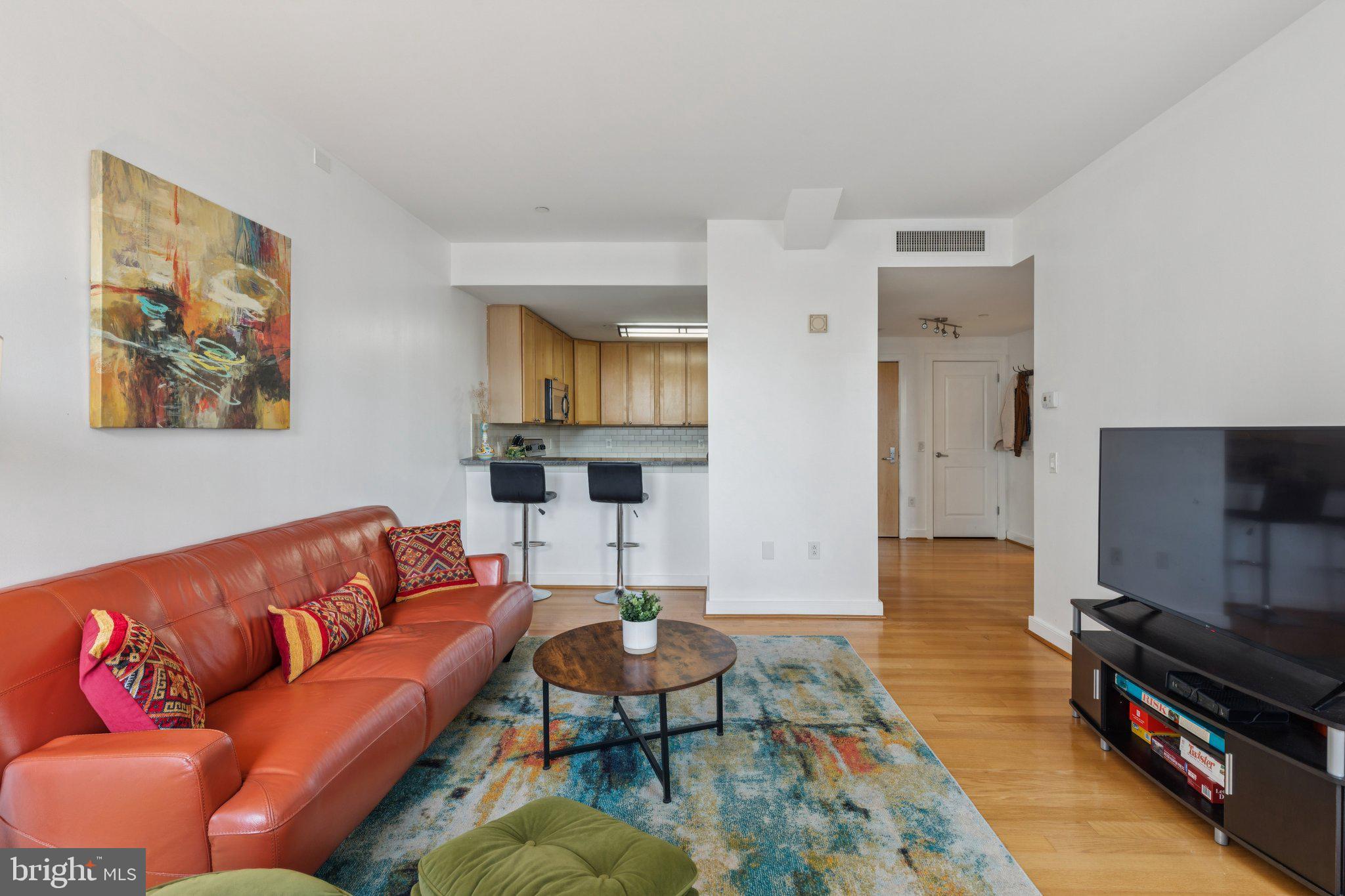 111 South 15th Street, Unit 2106 Philadelphia, PA 19102 - Photo 10 of 31 a living room with furniture and a flat screen tv