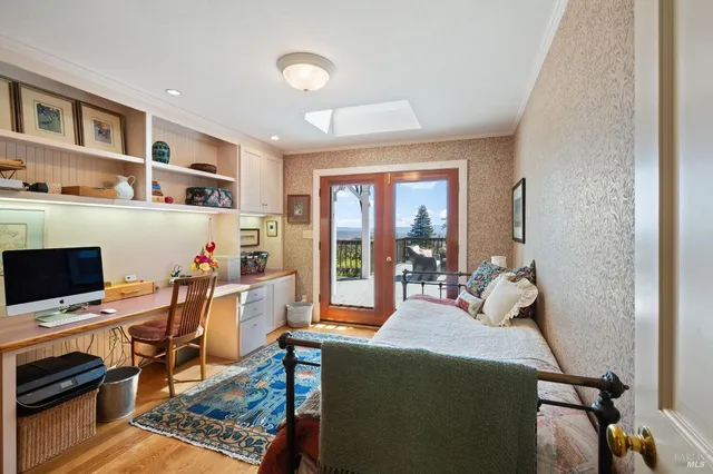 a bedroom with a bed and a desk