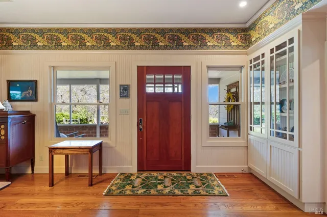 a living room with furniture a rug and a fireplace