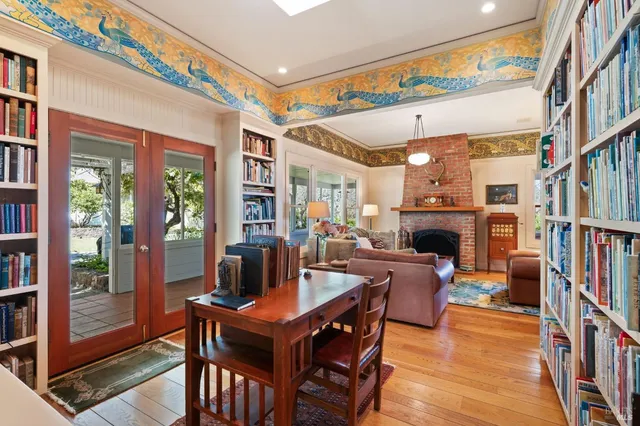 a living room with furniture a chandelier and a flat screen tv