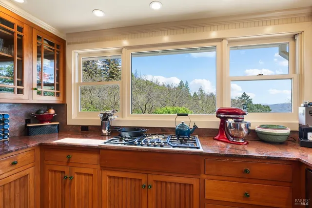 a kitchen with stainless steel appliances granite countertop a refrigerator and a stove top oven