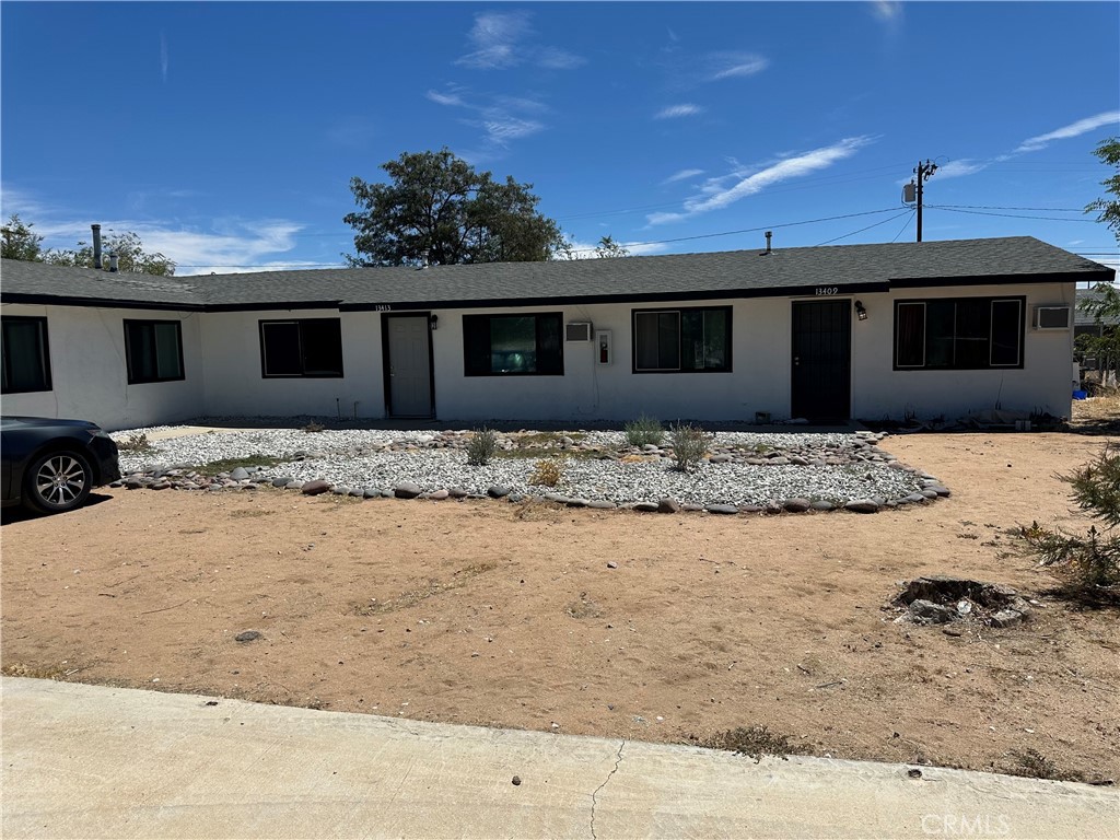 13409 Mohawk Road Apple Valley, CA 92308 - Photo 1 of 1 a front view of a house with a yard