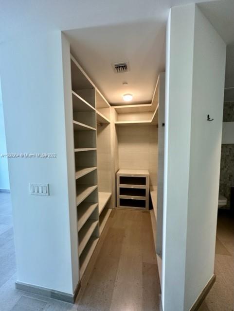 68 Southeast 6th Street, Unit 2507 Miami, FL 33131 - Photo 15 of 46 a view of walk in closet with empty racks