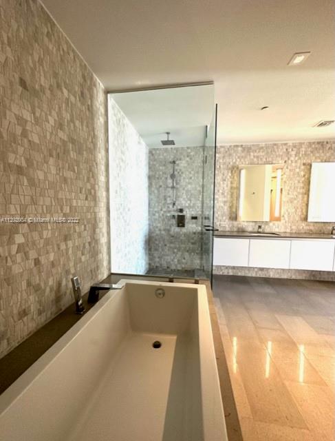 68 Southeast 6th Street, Unit 2507 Miami, FL 33131 - Photo 17 of 46 a view of a bathroom with a tub and sink