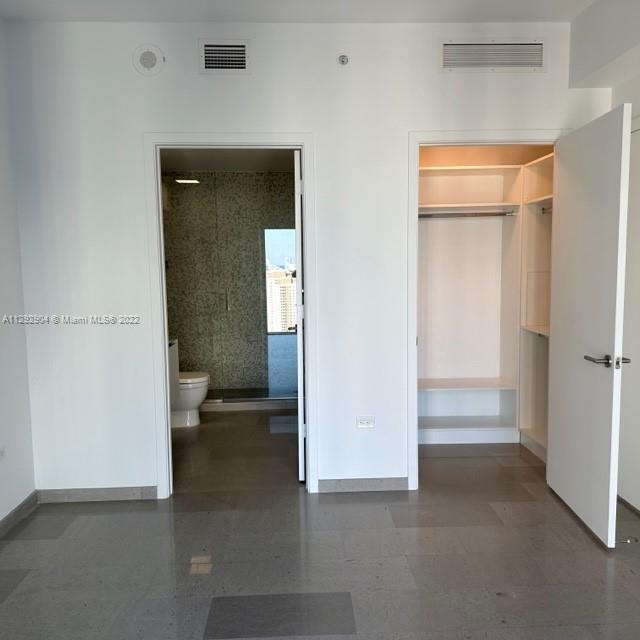 68 Southeast 6th Street, Unit 2507 Miami, FL 33131 - Photo 21 of 46 an empty room with a bathroom and a sink