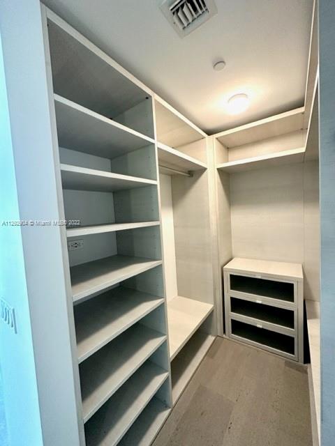 68 Southeast 6th Street, Unit 2507 Miami, FL 33131 - Photo 22 of 46 a view of walk in closet with empty racks