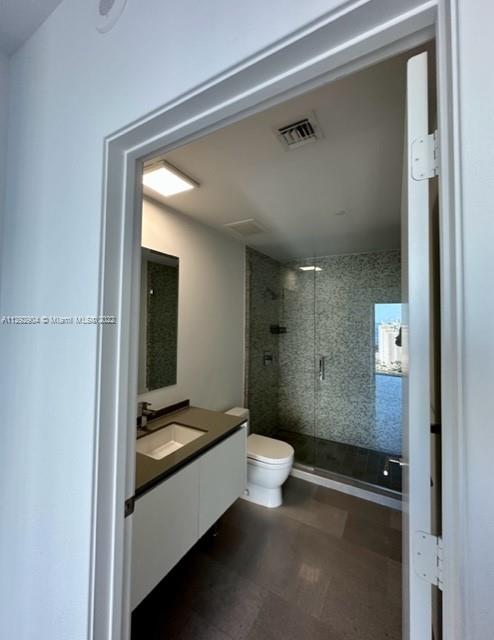 68 Southeast 6th Street, Unit 2507 Miami, FL 33131 - Photo 23 of 46 a bathroom with a sink a toilet and shower
