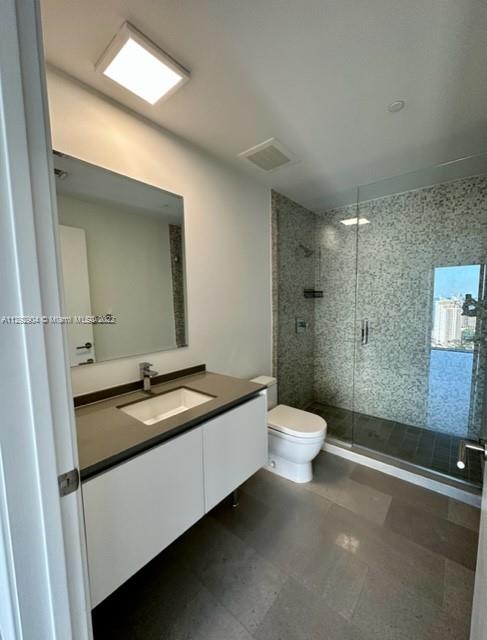 68 Southeast 6th Street, Unit 2507 Miami, FL 33131 - Photo 24 of 46 a bathroom with a granite countertop sink toilet a large mirror a shower and a bathtub