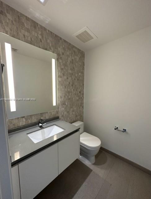 68 Southeast 6th Street, Unit 2507 Miami, FL 33131 - Photo 25 of 46 a bathroom with a sink and a toilet