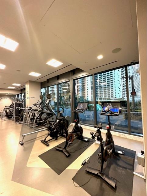 68 Southeast 6th Street, Unit 2507 Miami, FL 33131 - Photo 35 of 46 a room with gym equipment and a large window