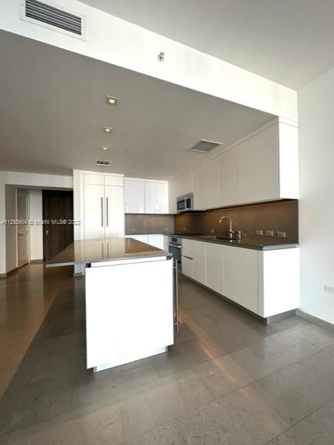 68 Southeast 6th Street, Unit 2507 Miami, FL 33131 - Photo 5 of 46 a view of kitchen with counter top space and cabinets