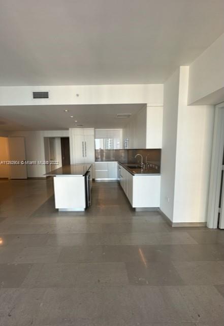 68 Southeast 6th Street, Unit 2507 Miami, FL 33131 - Photo 6 of 46 a view of kitchen with furniture and refrigerator