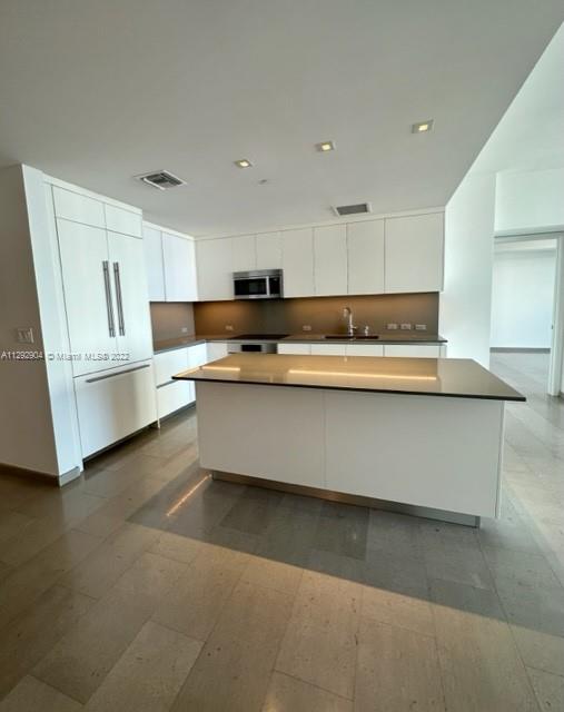 68 Southeast 6th Street, Unit 2507 Miami, FL 33131 - Photo 8 of 46 a view of kitchen with stainless steel appliances granite countertop a stove a sink and a refrigerator
