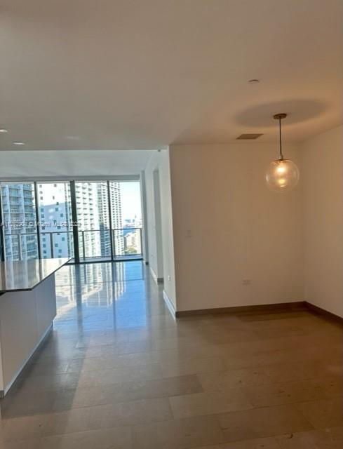 68 Southeast 6th Street, Unit 2507 Miami, FL 33131 - Photo 10 of 46 an empty room with wooden floor and windows