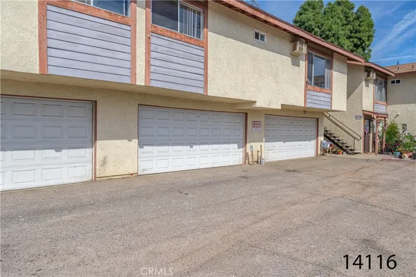 a view of a house with a yard and garage