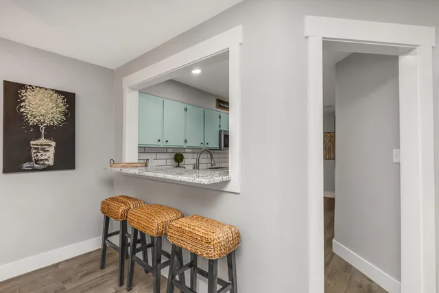 a living room with stainless steel appliances kitchen island granite countertop furniture and a fireplace