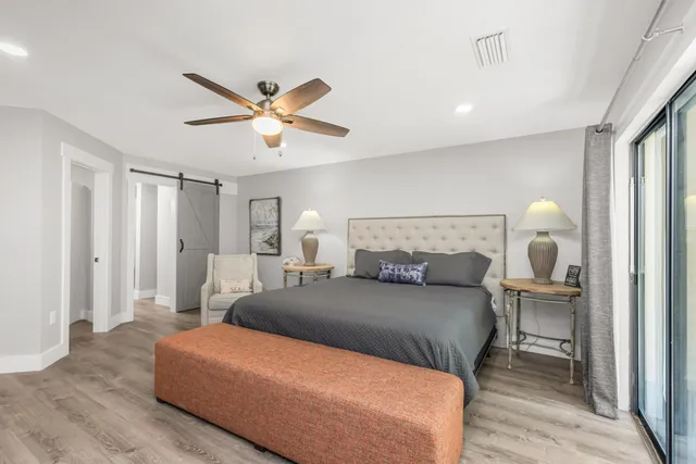 a living room with flat screen tv a ceiling fan and a fireplace