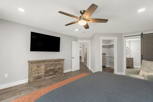 a bedroom with a bed and a television