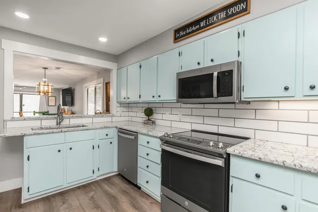 a kitchen with stainless steel appliances granite countertop a stove and a sink