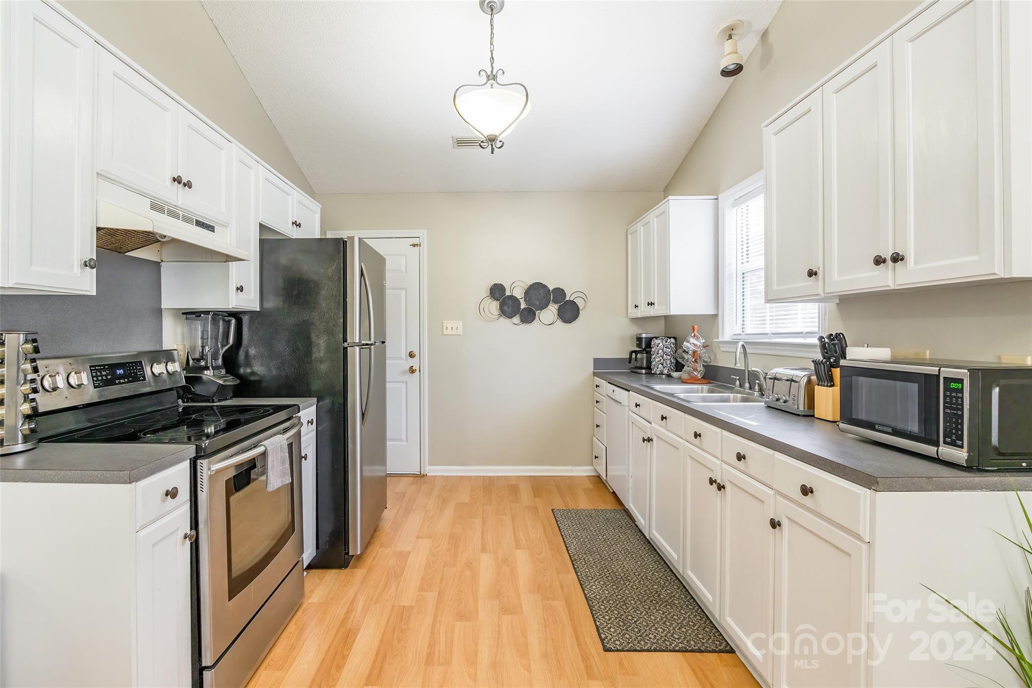 218 Bubbling Well Road Denver, NC 28037 - Photo 10 of 25 a kitchen with stainless steel appliances granite countertop a stove a sink and a refrigerator