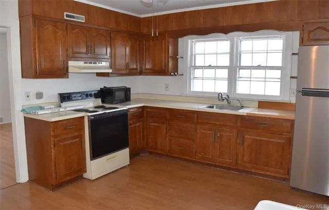 a kitchen with stainless steel appliances granite countertop a sink stove and cabinets