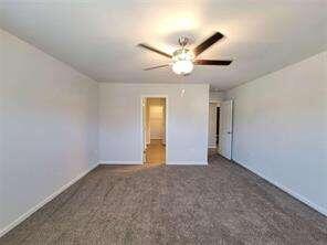 115 Deer Crossing Temple, GA 30179 - Photo 18 of 27 an empty room with a ceiling fan and a window