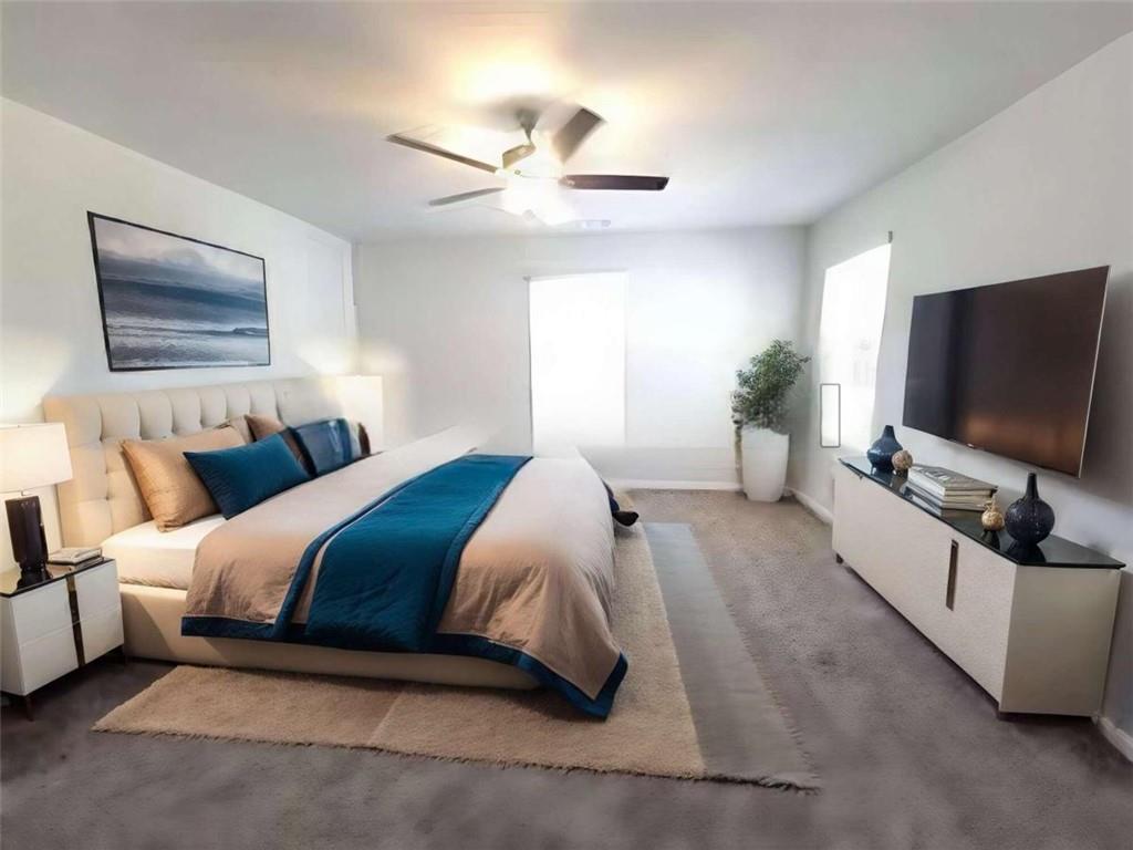 115 Deer Crossing Temple, GA 30179 - Photo 19 of 27 a spacious bedroom with a large bed and a flat screen tv