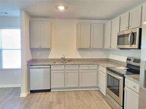 115 Deer Crossing Temple, GA 30179 - Photo 9 of 27 a kitchen with stainless steel appliances granite countertop a stove a sink and a microwave