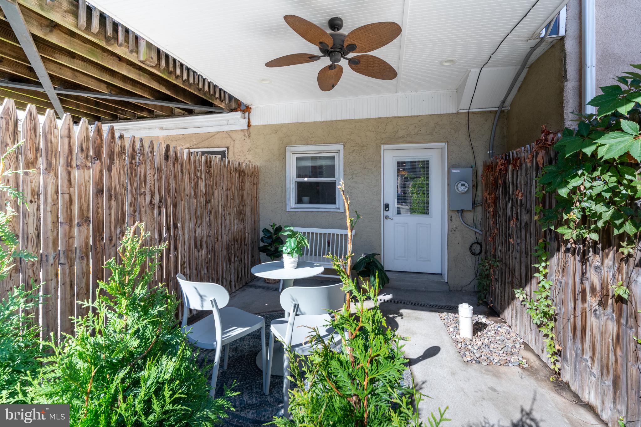 23 South Washington Street Baltimore, MD 21231 - Photo 11 of 57 a patio with table and chairs and potted plants