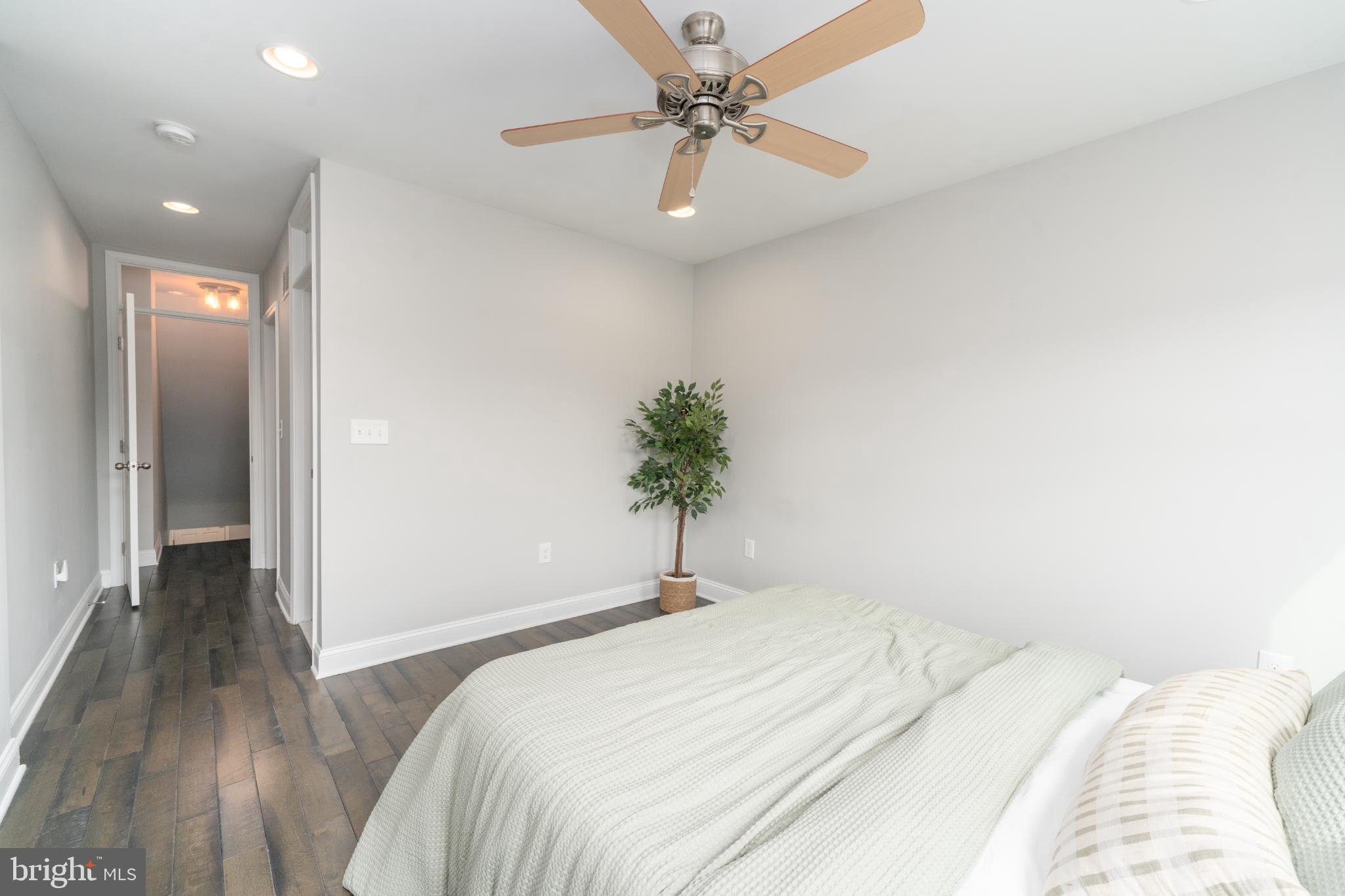 23 South Washington Street Baltimore, MD 21231 - Photo 15 of 57 a bedroom with a bed and a chandelier