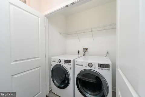 a bathroom with a granite countertop toilet and a sink