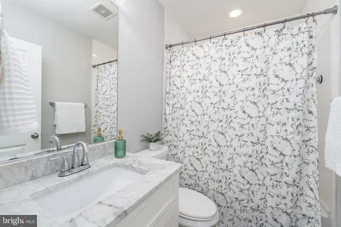 a bedroom with a bed and a ceiling fan