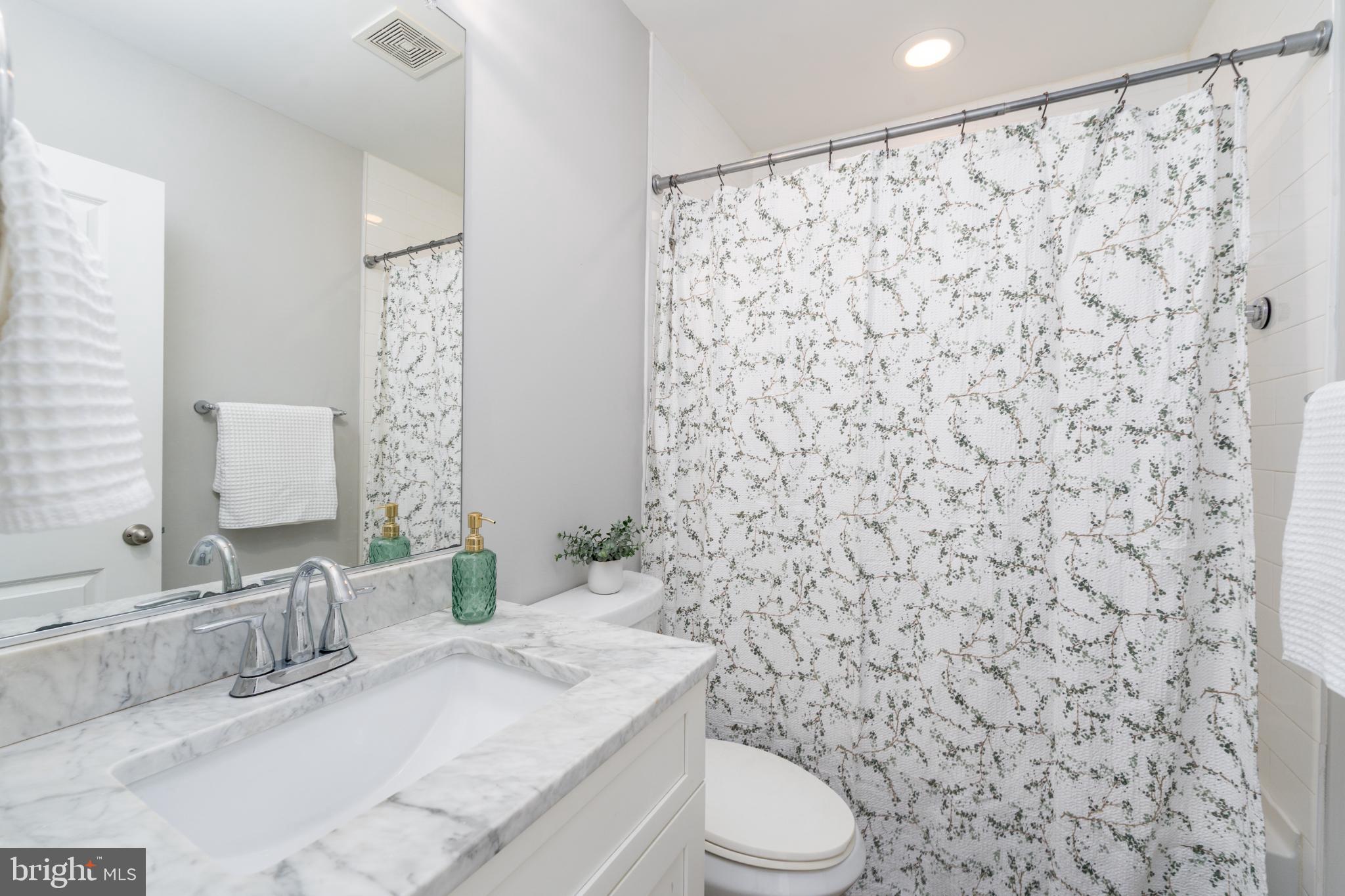 23 South Washington Street Baltimore, MD 21231 - Photo 18 of 57 a bathroom with a granite countertop toilet and a sink