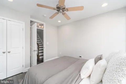 a bedroom with a large bed and a window