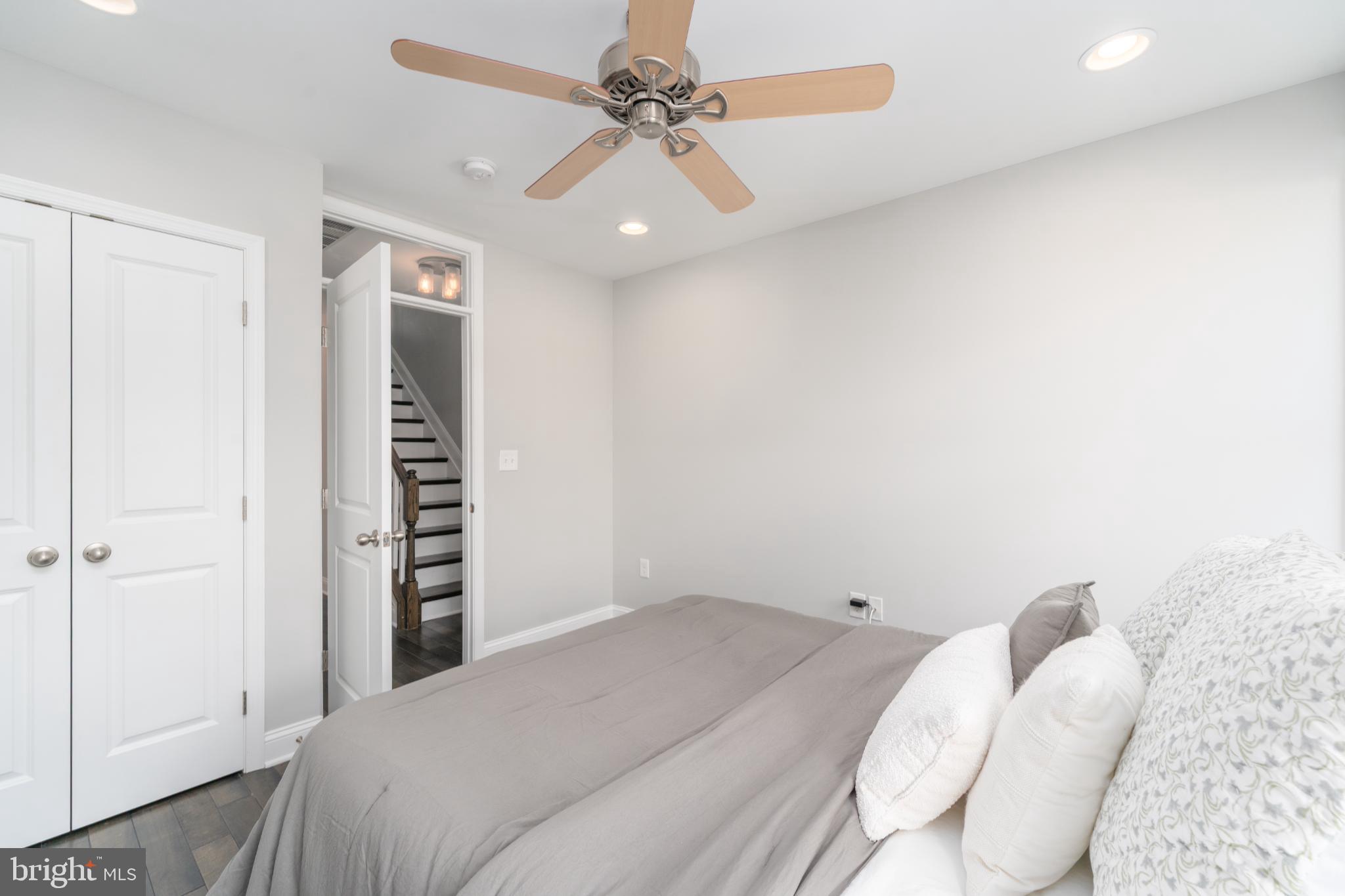 23 South Washington Street Baltimore, MD 21231 - Photo 19 of 57 a bedroom with a bed and a ceiling fan