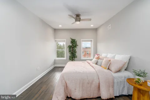 a bedroom with a bed and a potted plant
