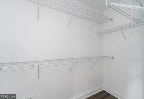 a bathroom with a granite countertop sink a mirror and shower