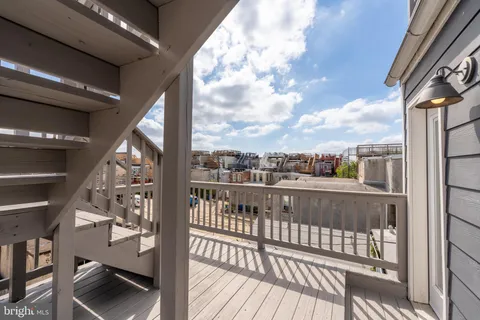 a balcony with wooden floor and potted plants