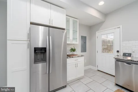 a kitchen with stainless steel appliances a refrigerator sink and cabinets